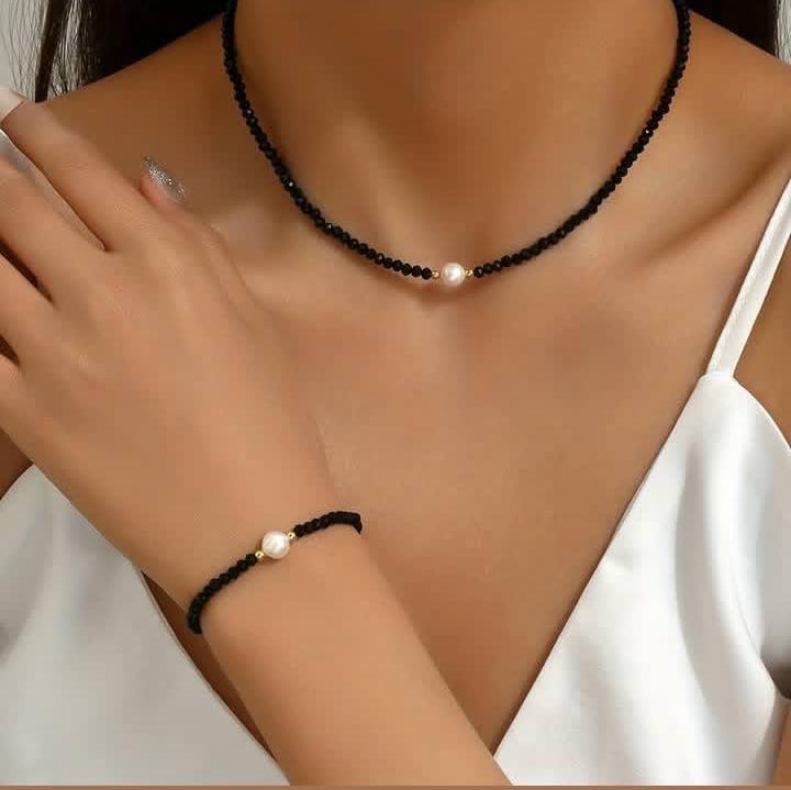 Minimalist black bracelet and necklace set featuring a white pearl. Handmade, elegant, and perfect for teenage girls' everyday style or gifting.
